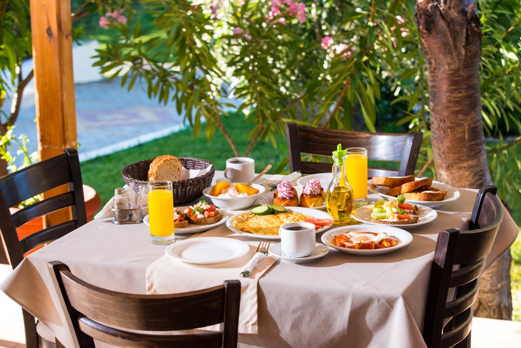 Breakfast table under the trees in the garden